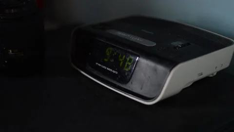 Digital alarm on a table in defocused background 스톡 동영상 166944374