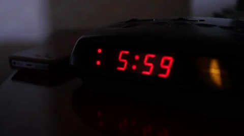 A digital alarm turns six and man turns off alarm Stock Footage