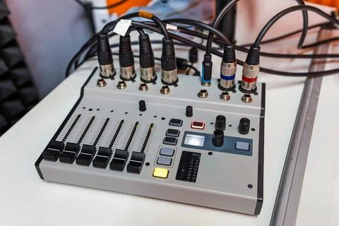 Digital audio mixing console with connected cables on studio desk Stock Photos