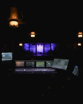 Digital audio mixing console with illuminated screens at live concert theater Stock Photos