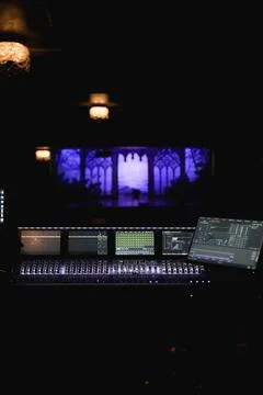 Digital audio mixing console with illuminated screens at live concert theater Stock Photos