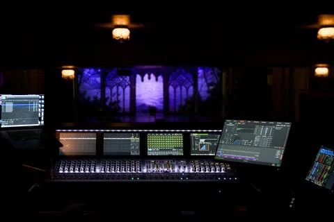 Digital audio mixing console with illuminated screens at live concert theater Stock Photos