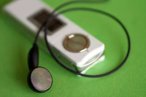 Digital audio player on green background Stock Photos