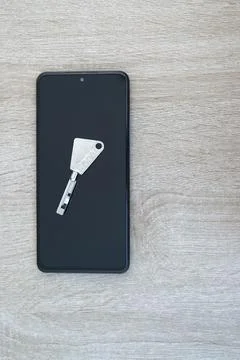 Digital authentication, security concept with key and smartphone Stock Photos