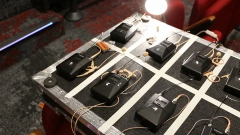 Digital AV equipment, wireless mics for an event, setup on flight case Stock Footage 98685309
