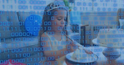 Digital binary code scrolling over birthday party revealing girl adjusting tiara 库存影片 318046069