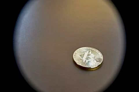 Digital bitcoin on a bronze background. Background. Stock Photos