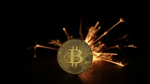 Digital bitcoins with fire sparks in the back Stock Footage 220936734