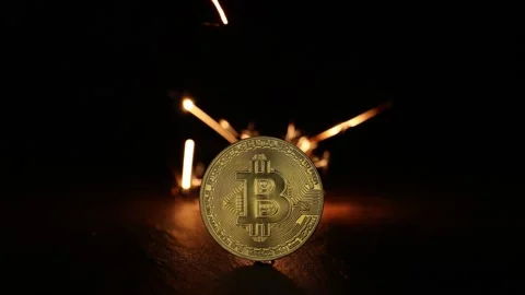 Digital bitcoins with fire sparks in the back Stock Footage 220936842