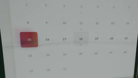 Digital calendar view with dates arranged in a grid, finger pressing date 18 Video stock 333860205