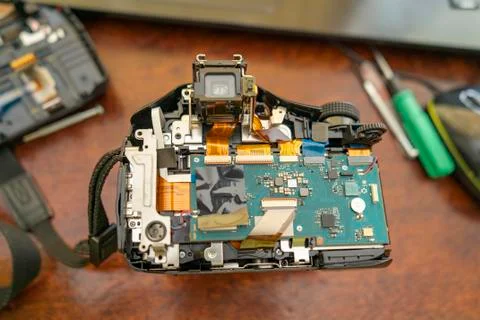 Digital camera with the back cover removed. Camera repair at home Stock Photos