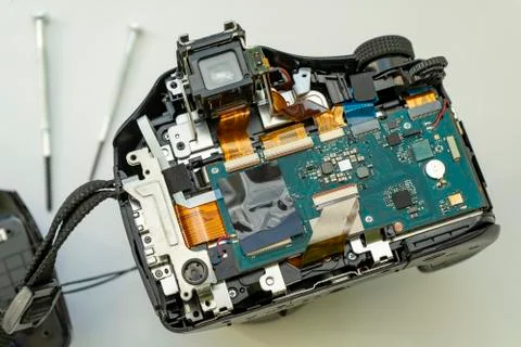 Digital camera with the back cover removed. Circuits and cables of the camera Stock Photos