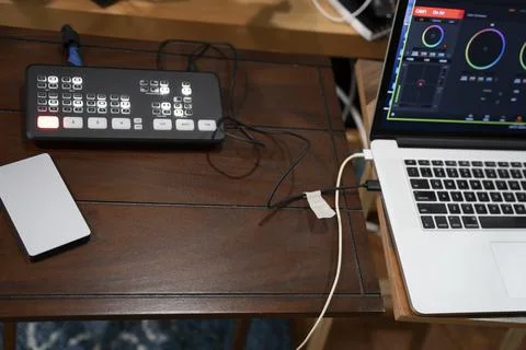 Digital camera control board and device charger on a small wooden table Stock Photos