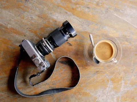 Digital camera with cup of coffee. Stock Photos