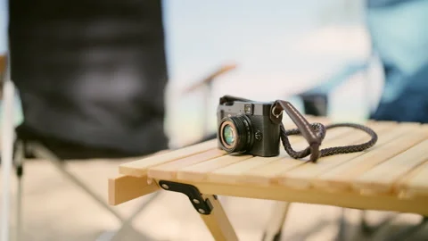 Digital camera on desk with sea view at beach camping Stock Footage 237630317
