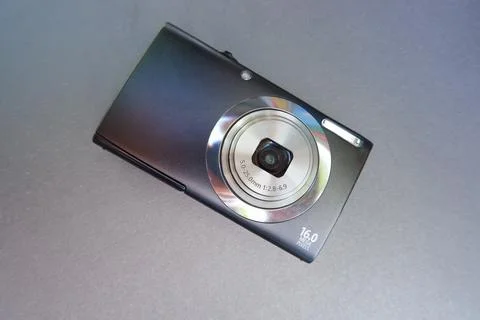 Digital camera on a gray background. St. Veronica's Day Photographer's Day . Stock Photos