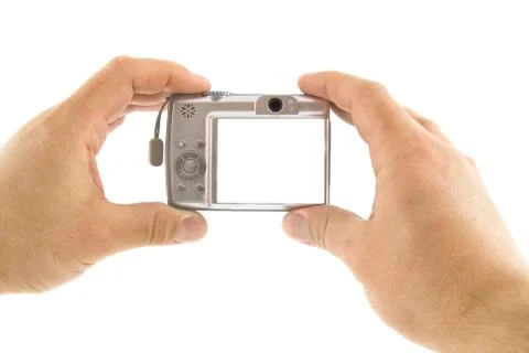 The digital camera in a hands isolated over white background Stock Photos
