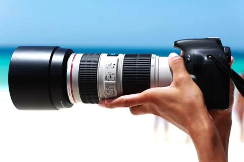 Digital camera in the hands of the photographer Stock Photos