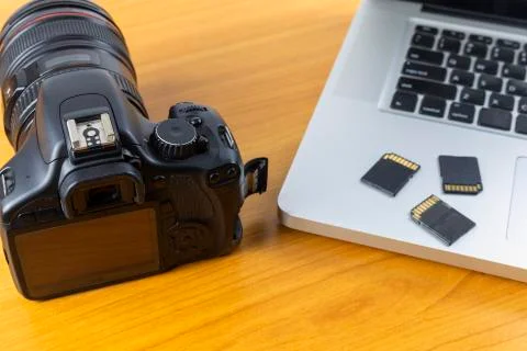 Digital camera, Laptop and memory card on wood table. With copy space for tex Stock Photos