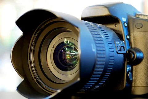 Digital camera lying on the table in the store. Stock Photos