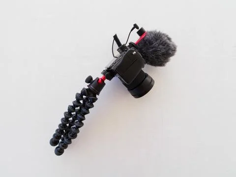 Digital Camera with microphone and tripod on white. Vlogging concept. Stock Photos