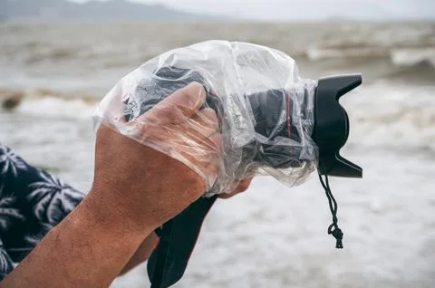 Digital camera in waterproof case and a protective plastic bag against rain Stock Photos