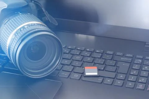 Digital camera wih memory card and laptop Stock Photos
