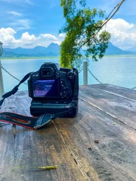 A digital camera on a wooden table Stock Photos