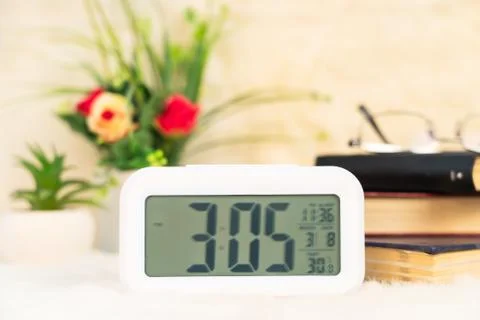Digital clock with book decorated on table Stock Photos