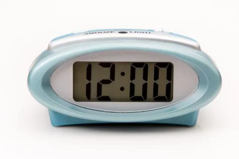 Digital clock displaying 12:00 o'clock on a white background. Stock Photos