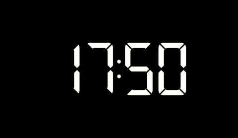 Digital clock displaying time in white digits against dark background for Stockillustratie