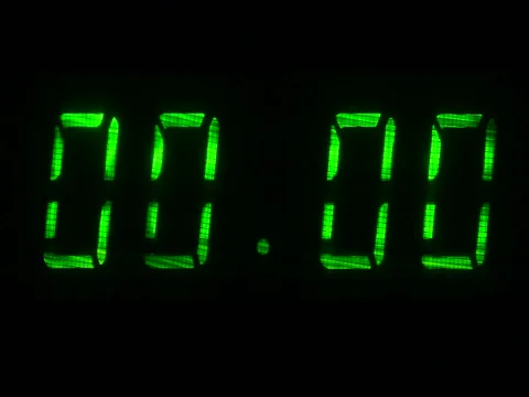 Digital clock with fluorescent display shows 00:00 in green color Stock Footage 75407107