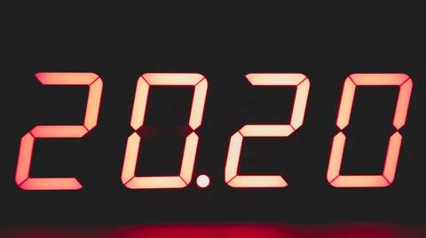 Digital clock with red led light illumination numbers 2020 in the dark Stock Photos