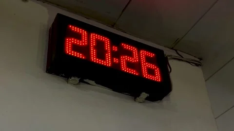 Digital clock with red LED lights changes time from 20:25 to 20:26 Stock Footage 325059617