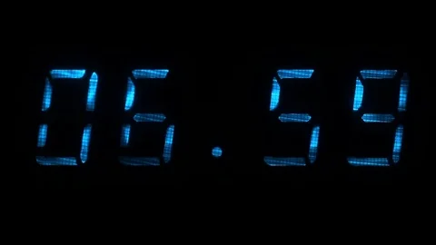 Digital clock shows time of 06 hours 59 minutes to 07 hours 00 minutes Stock Footage 71256276