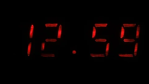 Digital clock shows the time of 12 hours 59 minutes to 13 hours 00 minutes Stock Footage 75169599