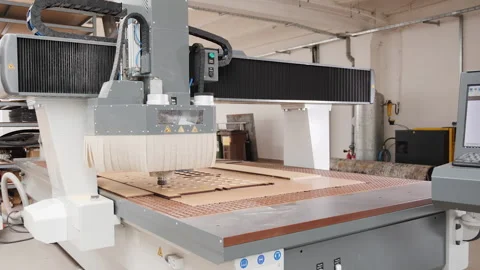 Digital cnc milling machine processing laser cut plywood board - wide shot Stock Footage 160824137