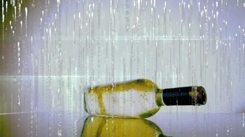 Digital code rain falling at frame two, glass wine bottle rotating showcasing 스톡 동영상 314455674