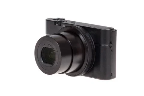 Digital compact camera with open lens isolated on white Stock Photos