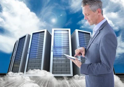 Digital composite image of businessman using digital tablet against server tower Stock Photos