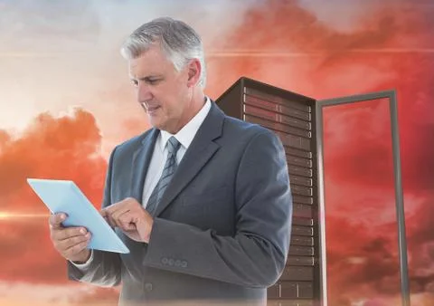 Digital composite image of businessman using digital tablet against server tower Stock Photos