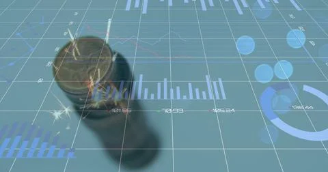 Digital composite image of financial data processing over stack of coins against Foto stock