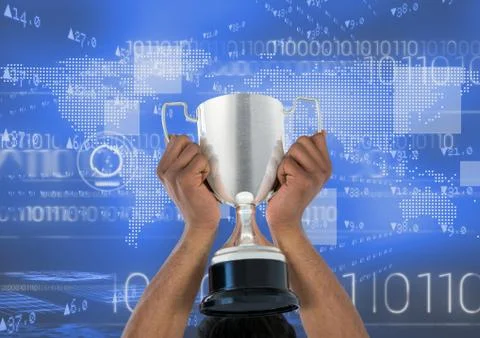 Digital composite image of hands holding trophy against binary codes Foto stock