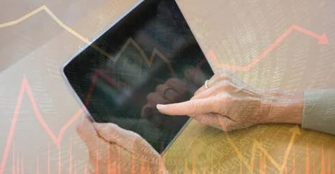 Digital composite image of hands using tablet PC with binary code and graphs 写真素材
