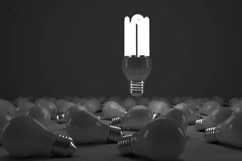 Digital composite image of lit energy efficient lightbulb over bulbs Illustrazione stock