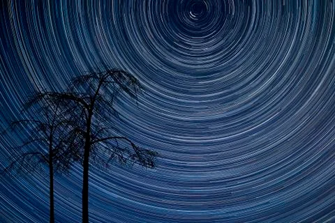 Digital composite image of star trails around Polaris with beautiful natural  Stock Photos