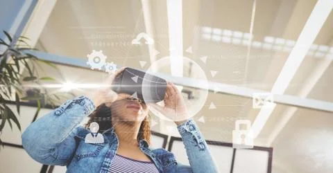Digital composite image of woman using VR glasses Foto stock