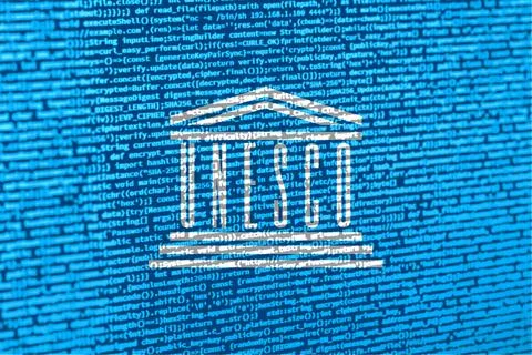 Digital concept with the flag of UNESCO on a tech background. UNESCO in the c Photos