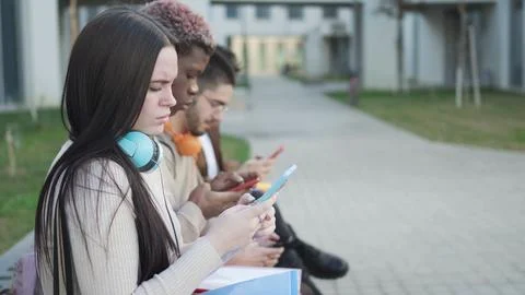 Digital Connection: young students absorbed in their virtual worlds Stock Photos