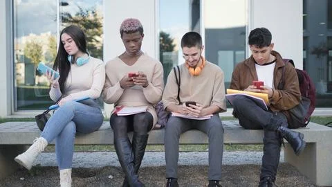 Digital Connection: young students absorbed in their virtual worlds Stock Photos